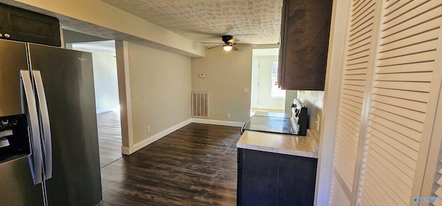 kitchen featuring a textured ceiling, visible vents, electric stove, stainless steel fridge with ice dispenser, and dark wood finished floors