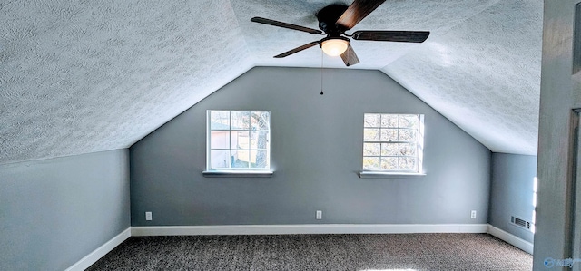 bonus room featuring carpet floors, a wealth of natural light, and a textured ceiling