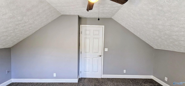 additional living space with a ceiling fan, vaulted ceiling, a textured ceiling, and baseboards