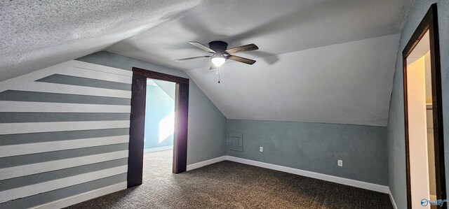 bonus room with a textured ceiling, carpet floors, a ceiling fan, baseboards, and vaulted ceiling