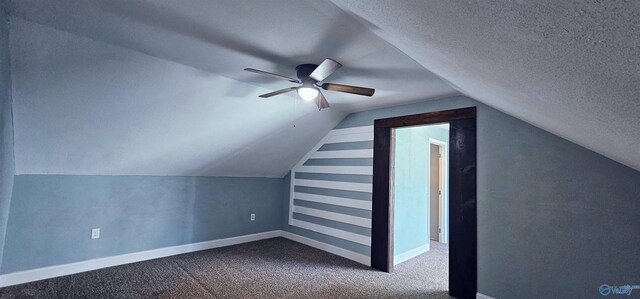 bonus room featuring a textured ceiling, carpet floors, a ceiling fan, baseboards, and vaulted ceiling