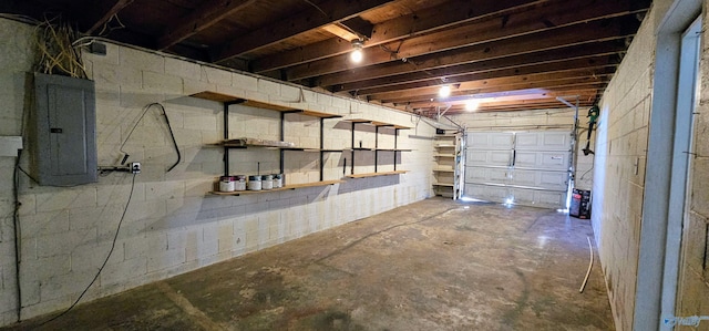 garage with concrete block wall and electric panel