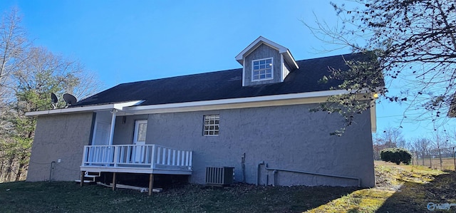 view of home's exterior with central air condition unit and stucco siding