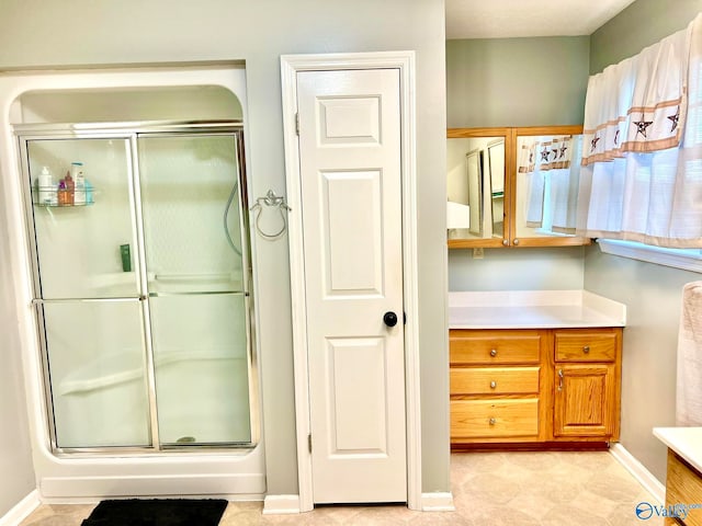 bathroom featuring vanity and an enclosed shower