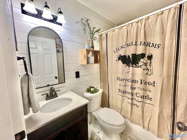 full bathroom featuring tile patterned flooring, a textured ceiling, toilet, shower / tub combo with curtain, and vanity