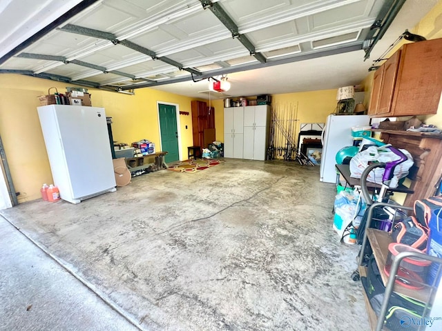 garage with white fridge and a garage door opener