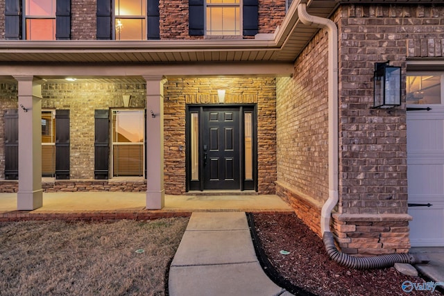 view of exterior entry with covered porch