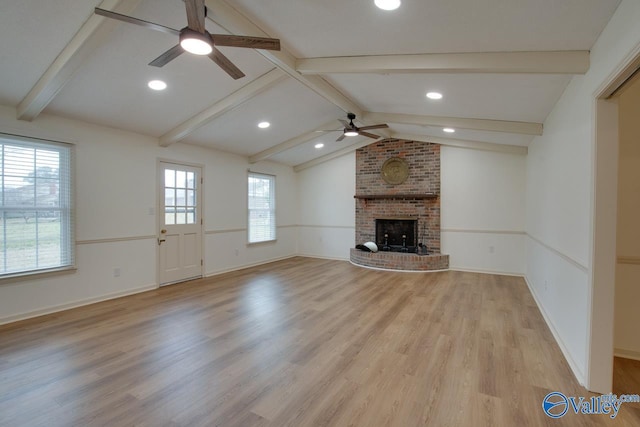 unfurnished living room featuring vaulted ceiling with beams, baseboards, ceiling fan, light wood-style flooring, and a fireplace