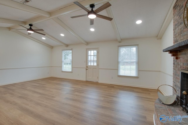 unfurnished living room featuring a brick fireplace, vaulted ceiling with beams, a ceiling fan, and wood finished floors