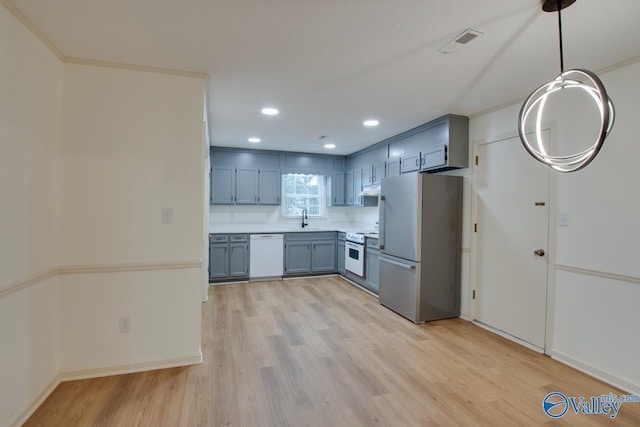 kitchen with visible vents, white appliances, light wood-style flooring, and light countertops