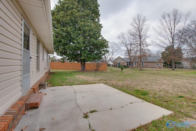 view of yard featuring fence and a patio area