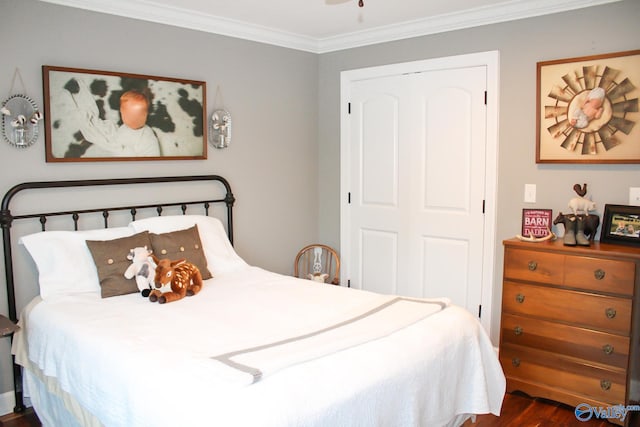 bedroom featuring a closet, crown molding, and dark hardwood / wood-style flooring