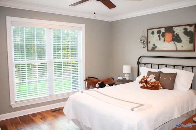 bedroom with ceiling fan, multiple windows, hardwood / wood-style floors, and crown molding