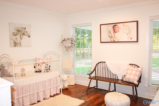 bedroom with ornamental molding, multiple windows, and dark hardwood / wood-style flooring