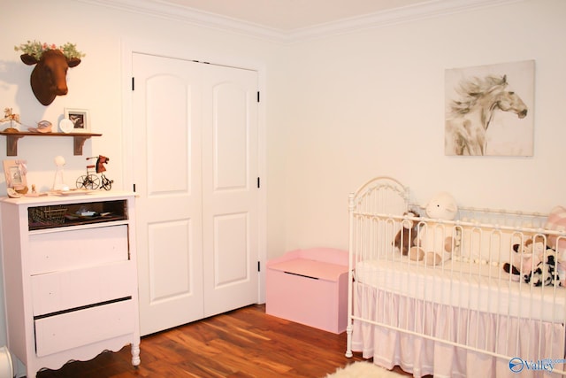 bedroom with ornamental molding, a closet, and dark wood-type flooring