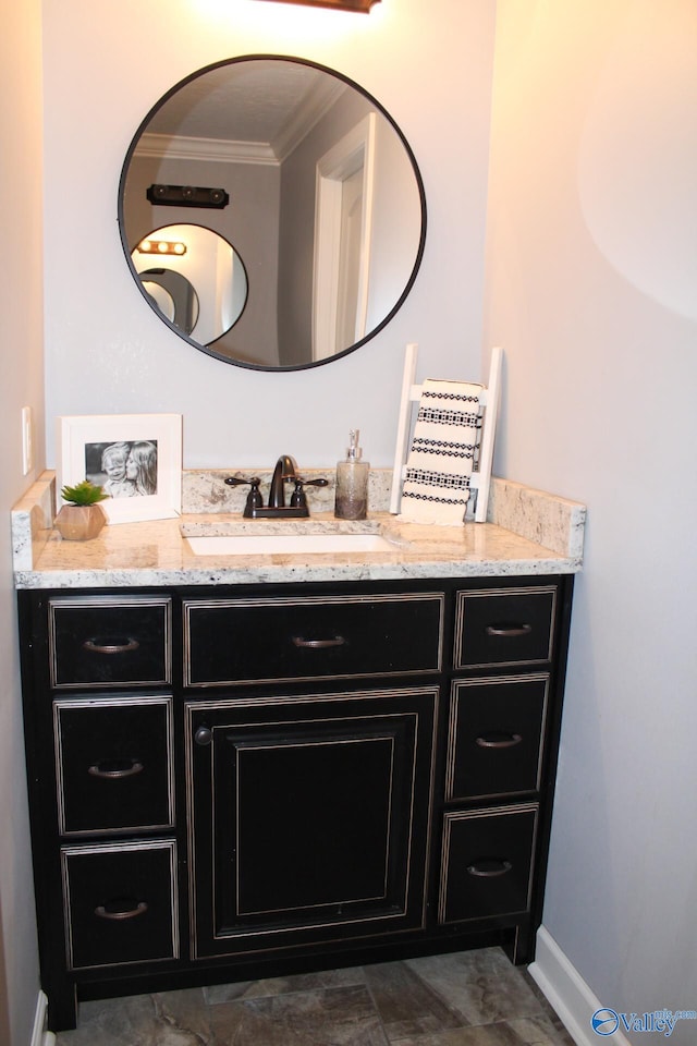 bathroom with ornamental molding and vanity