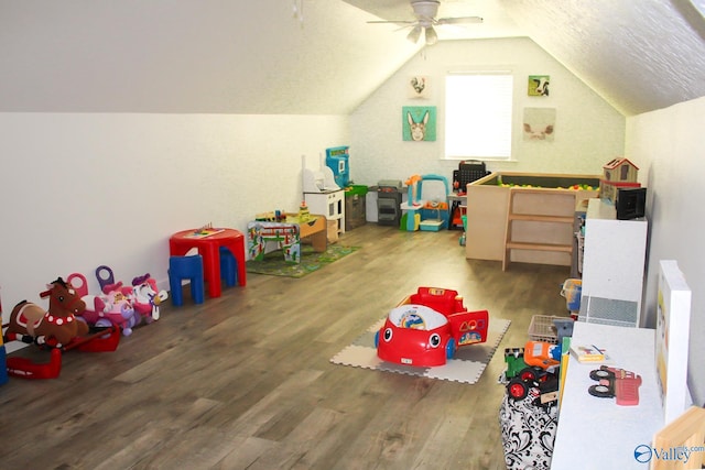 playroom with vaulted ceiling, ceiling fan, and hardwood / wood-style floors