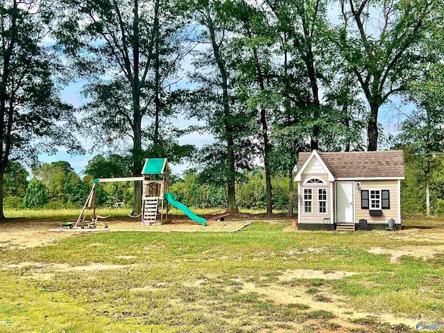 view of play area with a lawn and an outbuilding