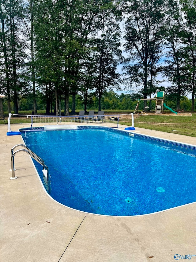 view of pool with a playground