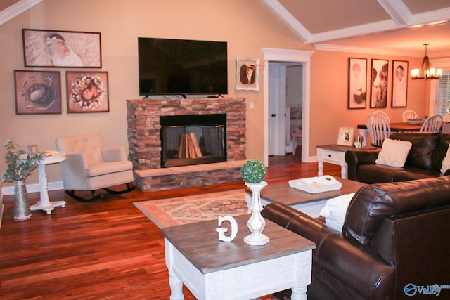 living room with a fireplace, crown molding, lofted ceiling, hardwood / wood-style floors, and a notable chandelier