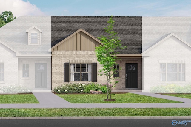 view of front of property featuring a front lawn, board and batten siding, a shingled roof, and brick siding