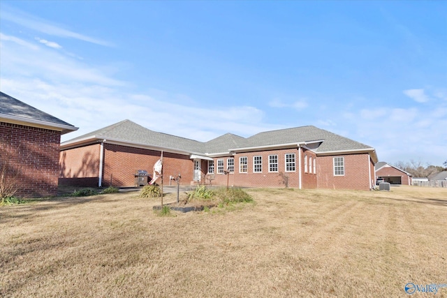 rear view of house featuring a patio and a lawn