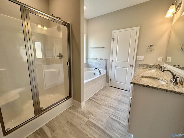 bathroom featuring vanity and independent shower and bath