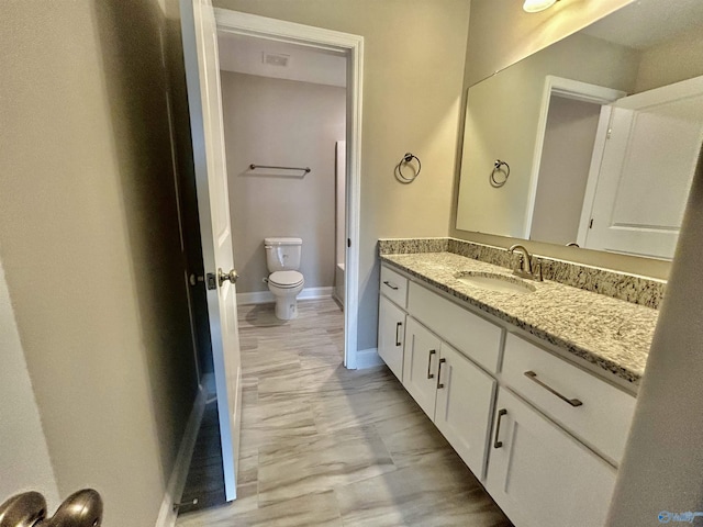 bathroom featuring vanity and toilet