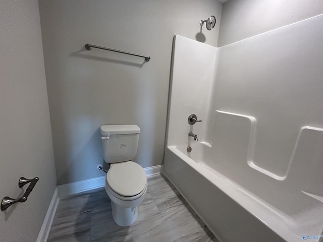 bathroom featuring shower / bathing tub combination and toilet