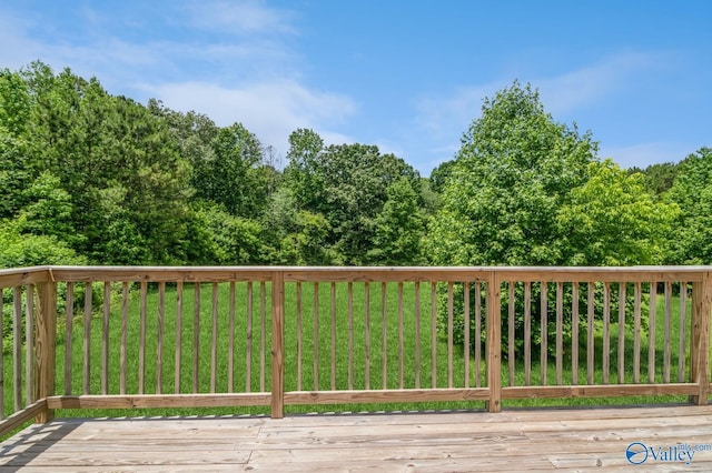 wooden terrace with a lawn