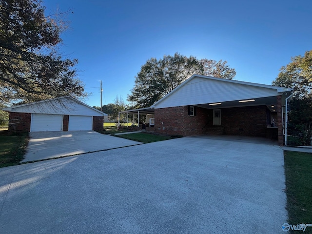 view of side of home featuring a yard, an outbuilding, and a garage