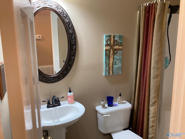 bathroom featuring sink and toilet