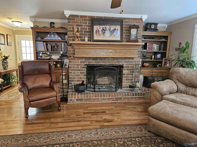 809 Kyle Rd NE, Hartselle, AL 35640 - living room featuring wood finished floors, crown molding, a fireplace, and a ceiling fan