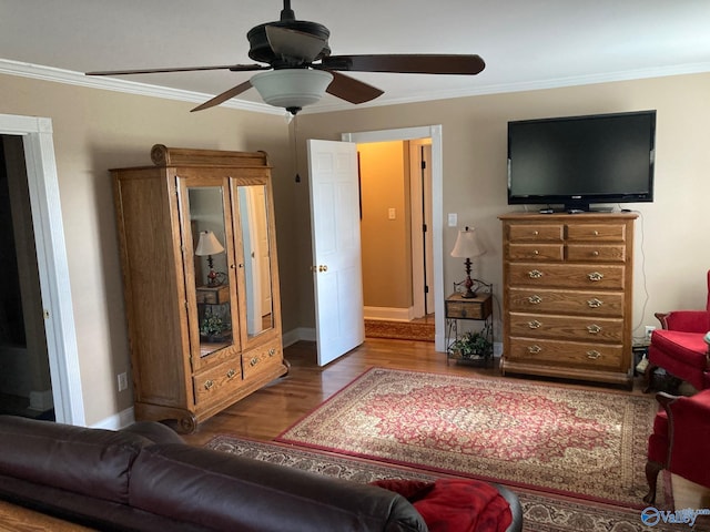 living room with hardwood / wood-style flooring, ceiling fan, and crown molding