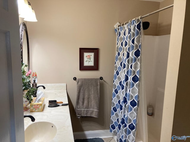 bathroom featuring curtained shower, tile patterned flooring, and vanity