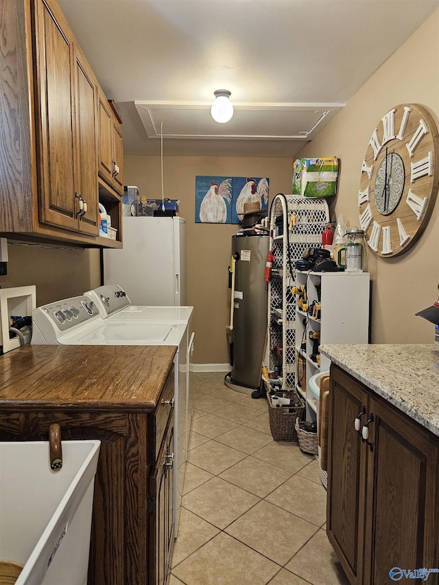 809 Kyle Rd NE, Hartselle, AL 35640 - washroom featuring attic access, washer and clothes dryer, water heater, light tile patterned floors, and cabinet space