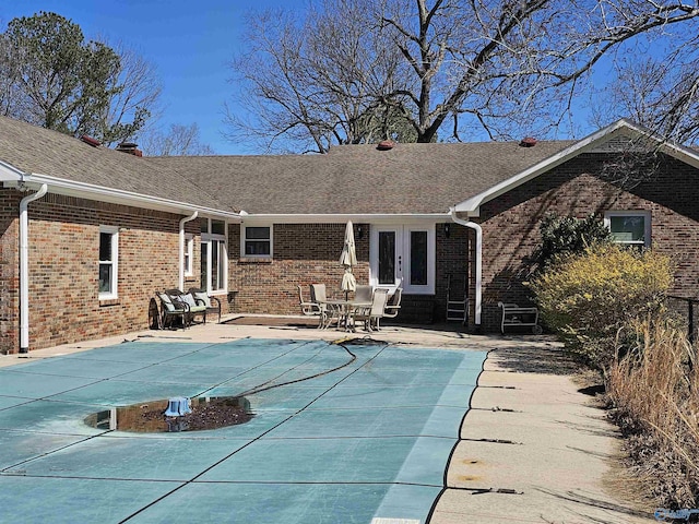 809 Kyle Rd NE, Hartselle, AL 35640 - back of house featuring brick siding, a patio, a shingled roof, and a covered pool