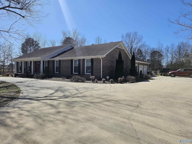 809 Kyle Rd NE, Hartselle, AL 35640 - view of front of house featuring brick siding, an attached garage, driveway, and a shingled roof