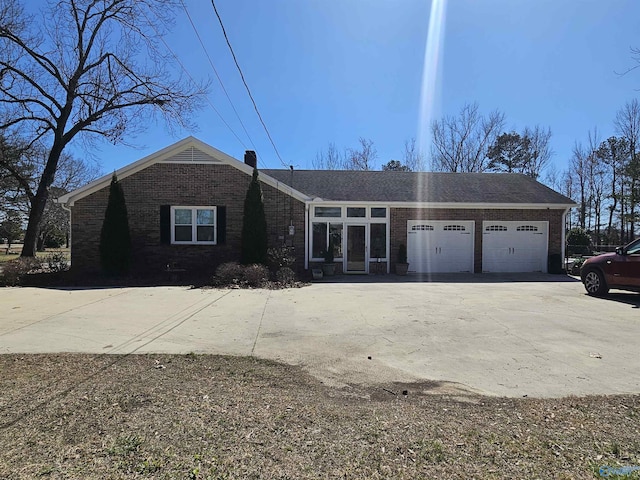 809 Kyle Rd NE, Hartselle, AL 35640 - view of front facade featuring brick siding, a garage, and driveway