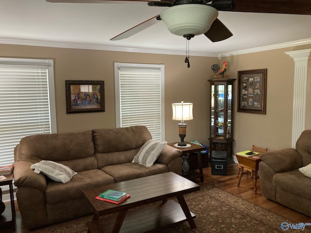 living room with ornate columns, ceiling fan, wood-type flooring, and ornamental molding