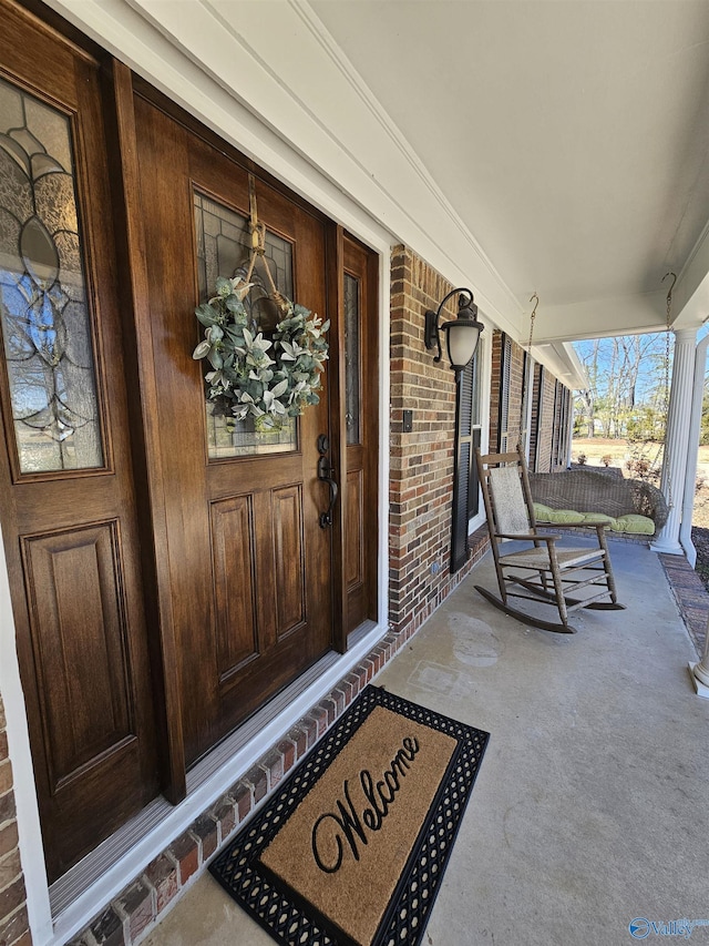 809 Kyle Rd NE, Hartselle, AL 35640 - view of exterior entry featuring a porch and brick siding