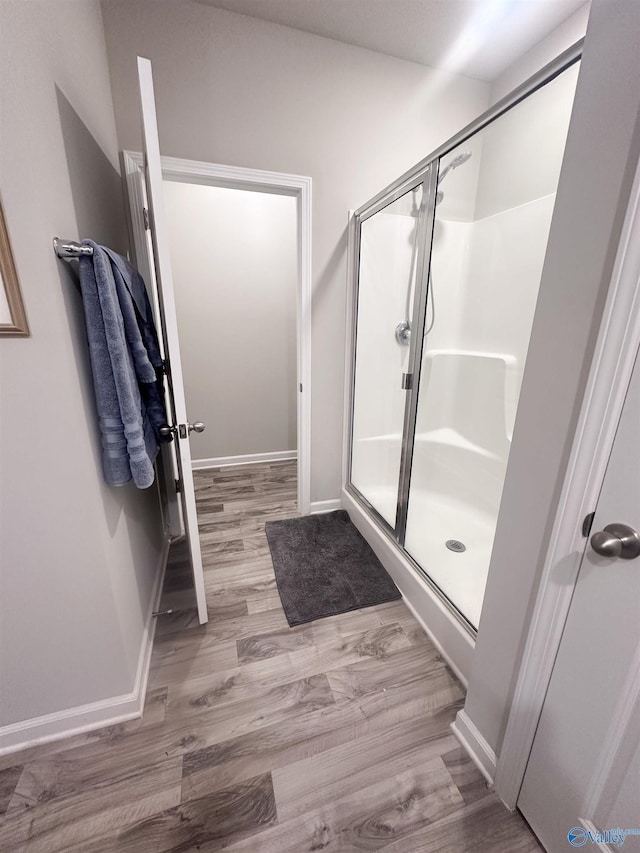 117 Edensmith Dr, New Market, AL 35761 - bathroom featuring a shower stall, wood finished floors, and baseboards