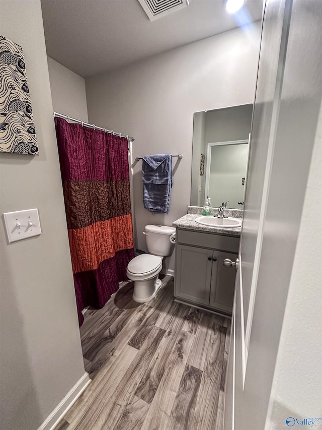 117 Edensmith Dr, New Market, AL 35761 - bathroom with wood finished floors, toilet, vanity, and a shower with shower curtain