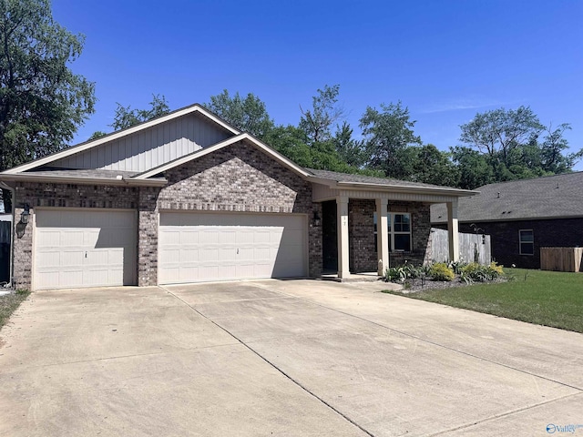 117 Edensmith Dr, New Market, AL 35761 - view of front facade featuring a garage, driveway, brick siding, and a front yard