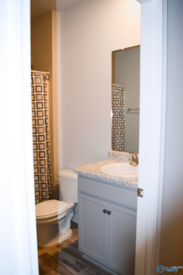 117 Edensmith Dr, New Market, AL 35761 - full bathroom featuring vanity, toilet, and wood finished floors