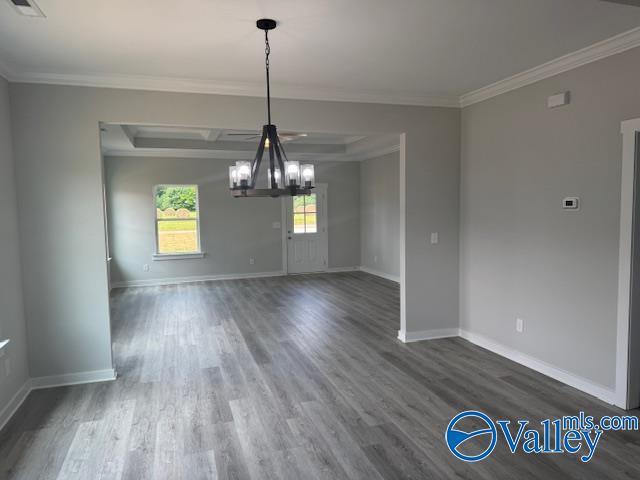 17194 Red Hill Rd, Athens, AL 35611 - unfurnished dining area with a chandelier, wood finished floors, and crown molding