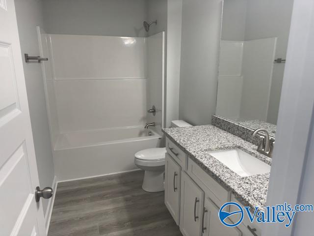 17194 Red Hill Rd, Athens, AL 35611 - bathroom featuring vanity, wood finished floors, and shower / bath combination