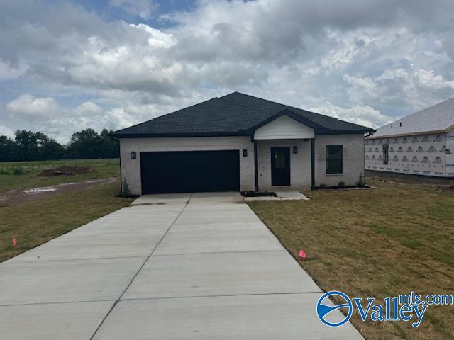 17194 Red Hill Rd, Athens, AL 35611 - ranch-style house featuring a garage, concrete driveway, and a front yard
