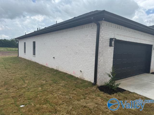 17194 Red Hill Rd, Athens, AL 35611 - view of side of property featuring brick siding, a yard, and a garage