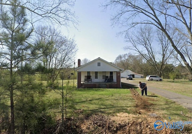 4470 Susan Moore Rd, Altoona, AL 35952 - bungalow-style home featuring covered porch, a front lawn, a chimney, asphalt driveway, and brick siding